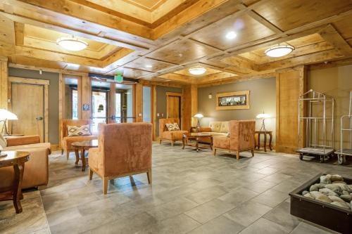 a living room with wooden ceilings and furniture at Trail Head Lodge # 302 in Cle Elum