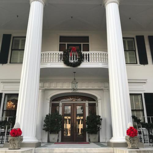 a white house with a wreath on the front door at 1842 Inn in Macon