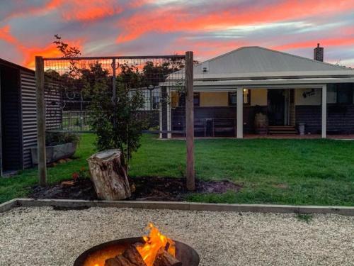 a fire pit in a yard in front of a house at Chesterfarm and Stables in Willyung