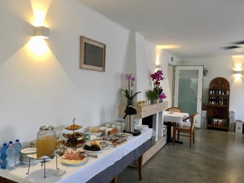 a buffet of food on a table in a room at Hotel Trieste in San Giórgio di Nogaro
