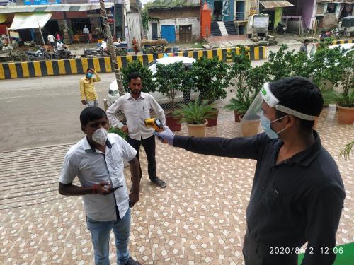 three people wearing face masks standing on a street at Hotel Radiance Courtyard in Varanasi