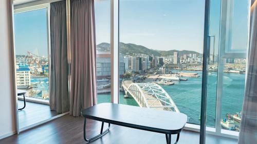 a room with a view of a bridge and water at Lavalse Hotel in Busan
