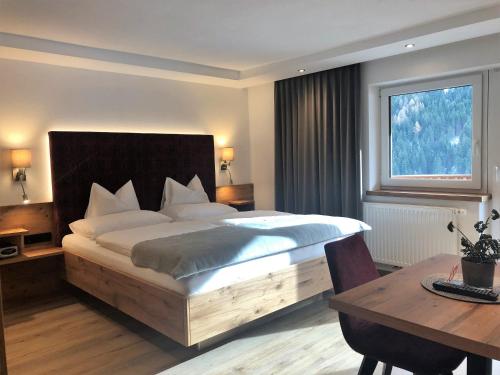 เตียงในห้องที่ Hotel Garni Central - Zimmer - Studios - Apartments