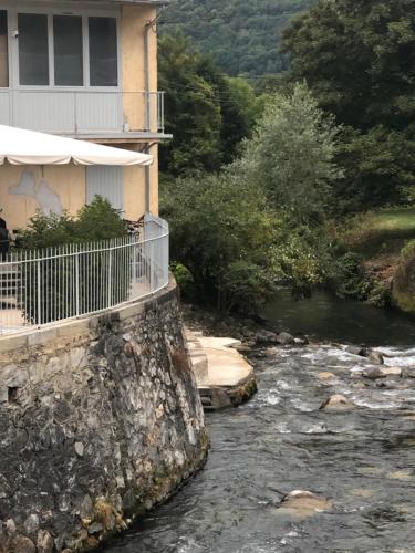 a river in front of a house with a building at LE 41 AVENUE FOCH in Luchon