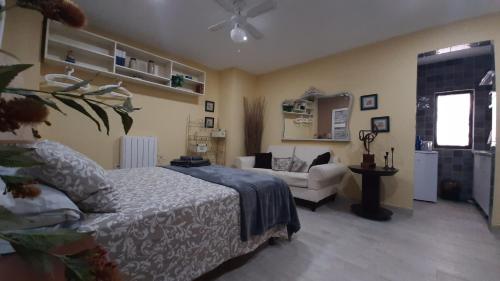 a bedroom with a bed and a couch at Casa solis in Leganés