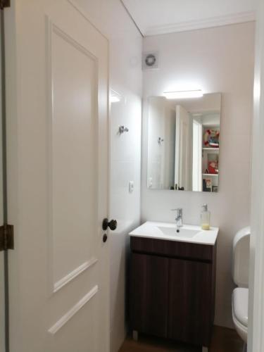 a bathroom with a sink and a mirror at São Roque View Apartment in Aveiro