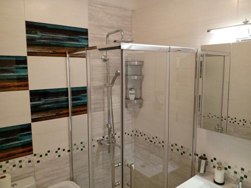 a bathroom with a shower and a sink at Valentina Bg Apartment in Sofia