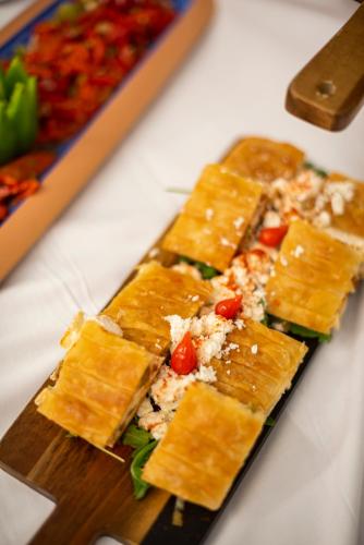 a bunch of food on a wooden cutting board at White Rock of Kos Hotel - Adults only in Kefalos