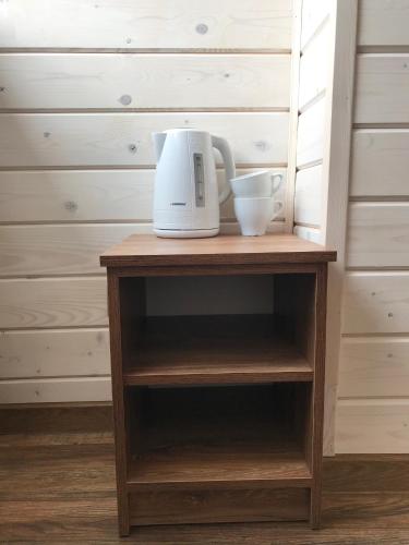 a coffee maker on top of a wooden shelf at готель Вікторія in Volovets