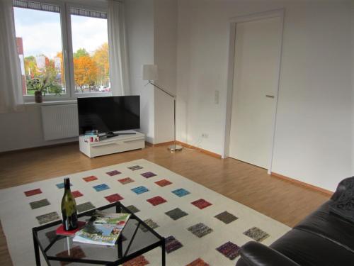 a living room with a couch and a table at K9 Wohnungen in Münster