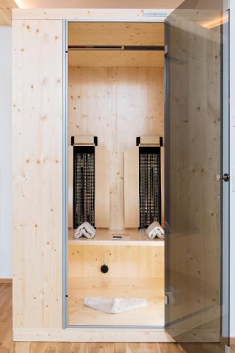 a wooden locker with two nets in a room at Alpenhotel Wanderniki in Liesing
