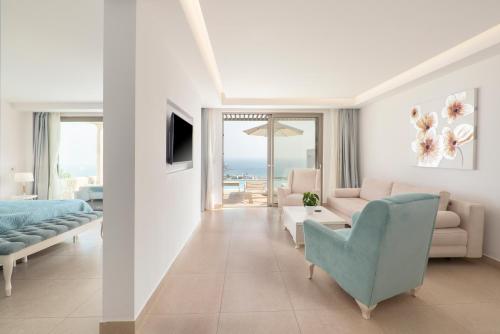 a living room with a couch and a chair at White Rock of Kos Hotel - Adults only in Kefalos