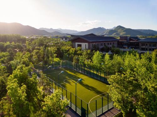 an overhead view of a tennis court with trees at Yanqi Hotel, Managed by Kempinski in Huairou