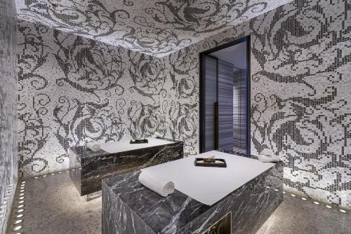 a bathroom with two sinks and a large mirror at Yanqi Hotel, Managed by Kempinski in Huairou