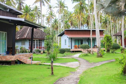 a resort with palm trees in the background at Koh Kood Far East Resort in Ko Kood