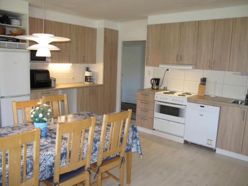 a kitchen and dining room with a table and chairs at Holiday Home Trollsjö Stegeborg by Interhome in Norrkrog