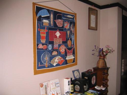 a picture hanging on a wall in a room at Ryokan Mikasaya in Beppu