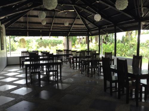 a dining room with tables and chairs in a room at Balay Tuko Garden Inn in Puerto Princesa City