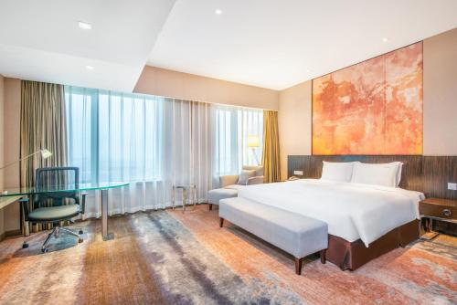 a hotel room with a bed and a desk at Holiday Inn Nanjing Aqua City by IHG in Nanjing