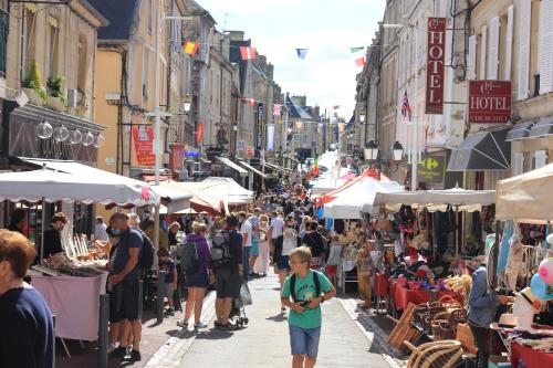 een menigte mensen die door een straatmarkt lopen bij Le 31bis Mathilde Centre historique in Bayeux