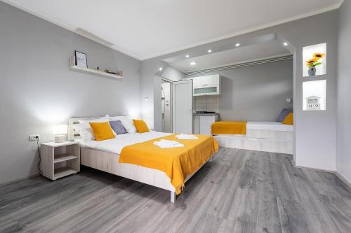 a bedroom with two beds and a large mirror at Rtanjska bajka in Boljevac