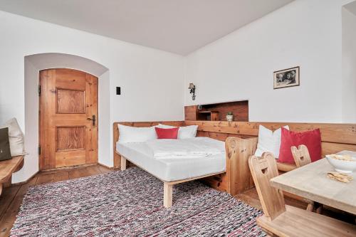 a living room with a bed and a table and a table sidx sidx at Marbergerhaus Umhausen in Umhausen