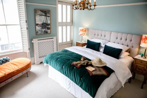 a bedroom with a bed with a teddy bear on it at Moore House in Hastings