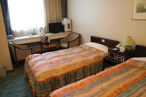 Een bed of bedden in een kamer bij Hotel Abest Aomori