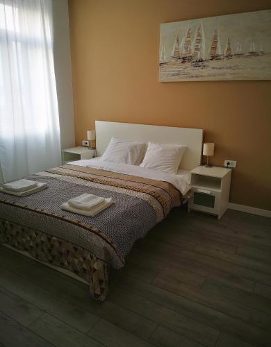 a bedroom with a bed with two towels on it at Old Town in Pula
