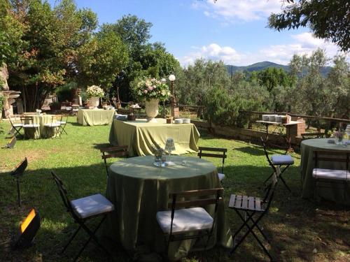 a group of tables and chairs in the grass at Villa Dell'Annunziata in Rieti
