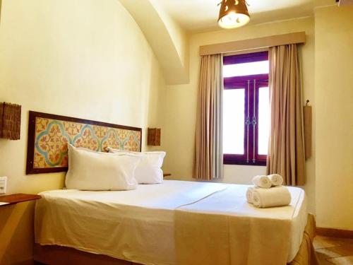 A bed or beds in a room at Pousada Fortal Villa Praia