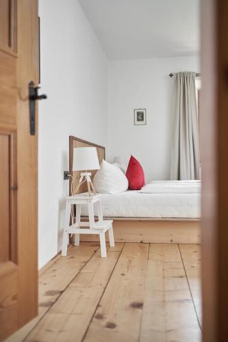 a bedroom with a bed and a chair in it at Marbergerhaus Umhausen in Umhausen
