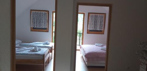 a bedroom with two beds and a mirror at Holiday Home Adna in Bihać