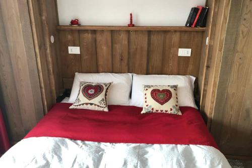 a bed with two pillows on top of it at Piccolo paradiso in centro Cervinia in Breuil-Cervinia