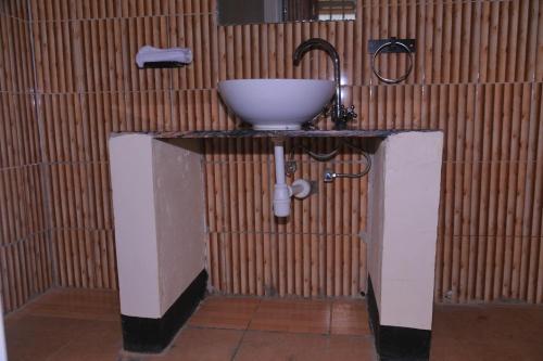 a bathroom with a sink on a counter at Acaki Lodge in Kitgum