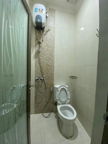 a bathroom with a toilet and a shower at Anugrah Inn in Nalagat