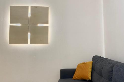 - un salon avec un canapé et une lumière sur le mur dans l'établissement Beautiful appartment in the Vieille Ville d'Annecy at 200m from the lake, à Annecy
