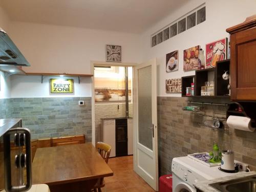 a kitchen with a table and a counter top at Casa Vacanze Villa Pompeiana in Trieste