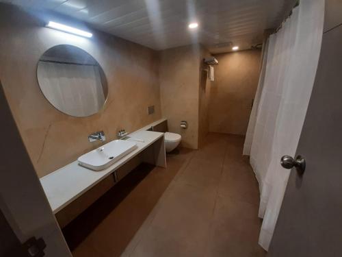 a bathroom with a sink and a mirror and a toilet at VITS The Somnath Gateway in Somnath