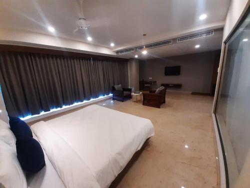 a hotel room with a bed and a living room at VITS The Somnath Gateway in Somnath