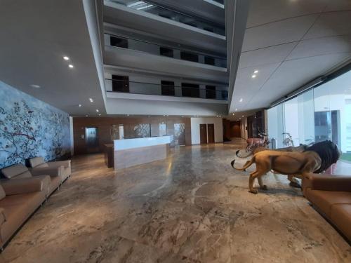 a large lobby with a large animal standing in the middle at VITS The Somnath Gateway in Somnath