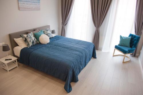- une chambre avec un lit bleu et une chaise bleue dans l'établissement Kungu Apartments in Riga Old Town, à Riga