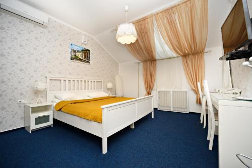 a bedroom with a bed and a window at Denisovsky Dvorik in Moscow