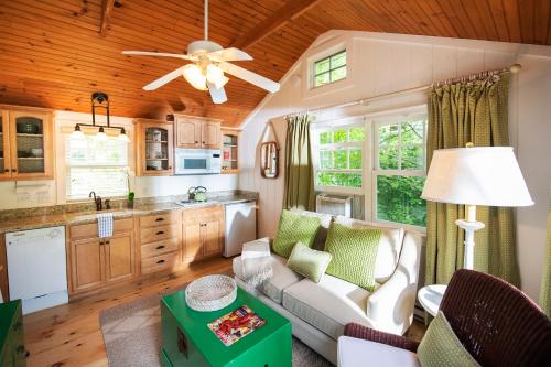 a kitchen and living room with a couch and a table at The Cottages at Cabot Cove in Kennebunkport