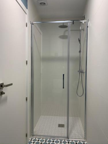 a shower with a glass door in a bathroom at Sereíña Beach in Vigo