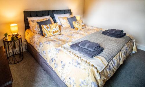 a bedroom with a large bed with blue towels on it at Wuthering Heights in Sedbergh