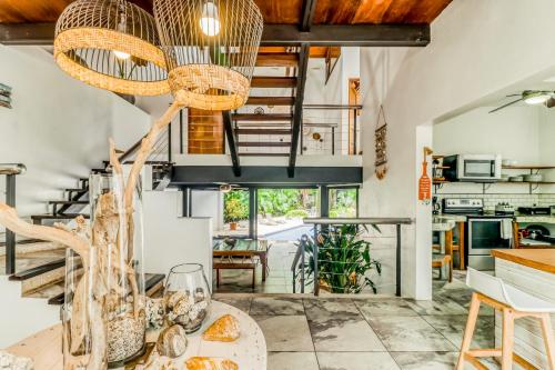 a living room with a staircase and a table with food at Casa Guarumo Carrillo in Carrillo