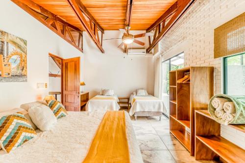 a living room with two beds and a table at Casa Guarumo Carrillo in Carrillo