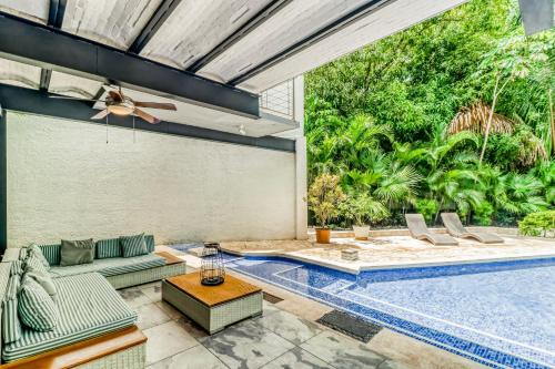 an outdoor patio with a swimming pool and a patio furniture at Casa Guarumo Carrillo in Carrillo