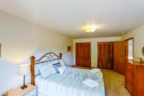 a bedroom with a bed with a blue comforter at LKA Getaway in Bumpass